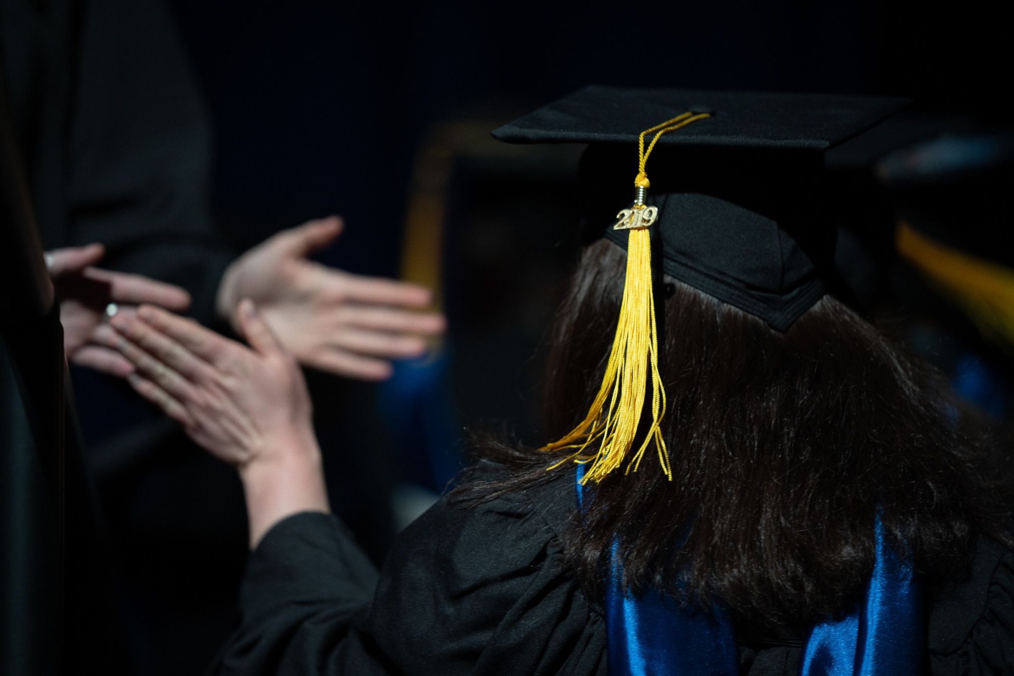 Students high five during graduation